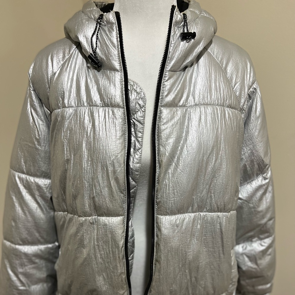 Silver puffer jacket with flaws